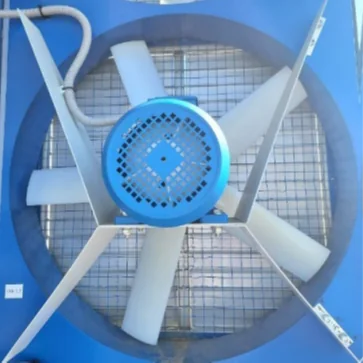A large exhaust fan with a blue motor mounted in a mining container wall